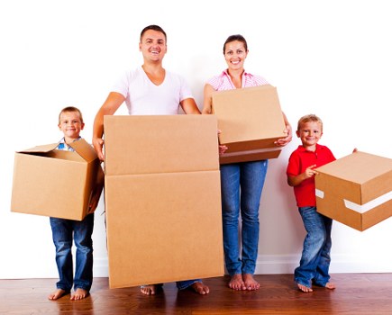 Professional movers handling flat removals in Queenspark near an apartment entrance