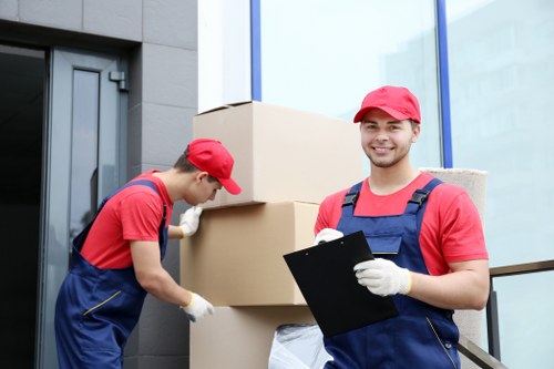 Furniture pick-up service removing a sofa in Queenspark