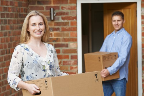 Professional piano movers handling a careful removal in Queens Park