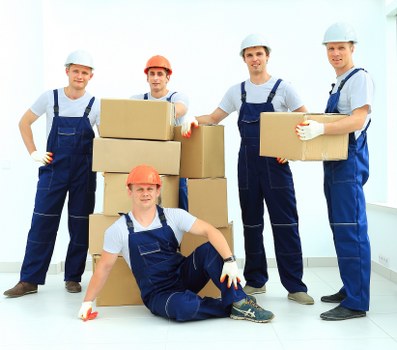Team safely loading items into a van as part of a moving service